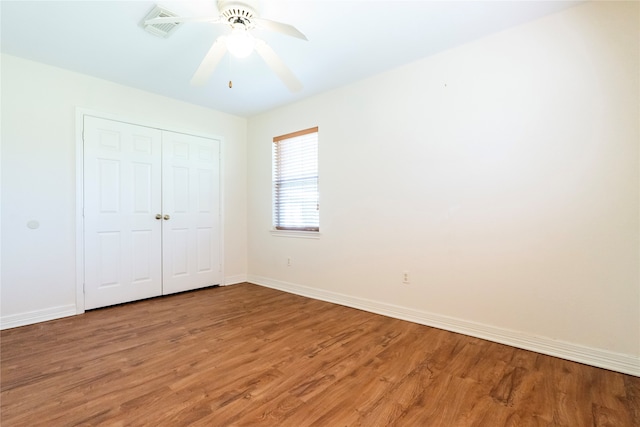 unfurnished bedroom featuring a closet, ceiling fan, and wood-type flooring