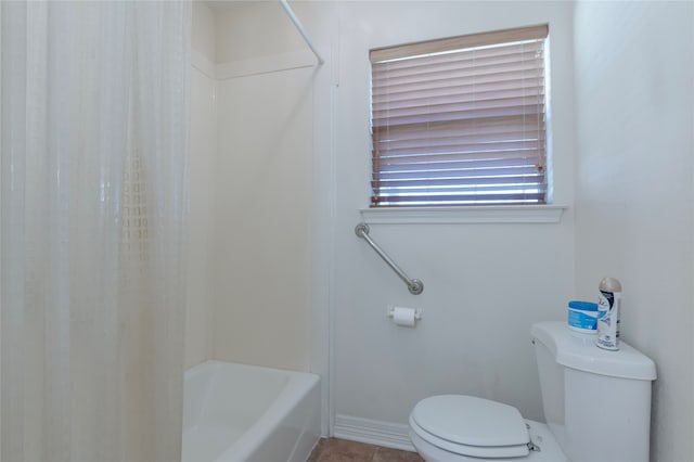 bathroom featuring tile patterned floors, shower / bath combo with shower curtain, and toilet