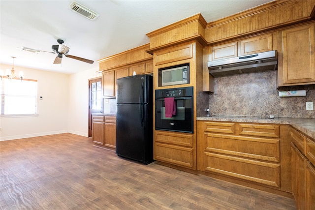 kitchen with decorative backsplash, black appliances, decorative light fixtures, ceiling fan with notable chandelier, and dark hardwood / wood-style flooring