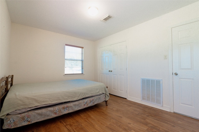 bedroom featuring hardwood / wood-style flooring and a closet