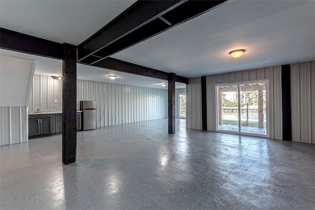 basement with stainless steel refrigerator