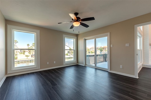 spare room with ceiling fan and dark wood-type flooring