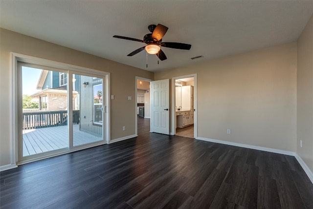 interior space featuring ceiling fan, ensuite bath, dark hardwood / wood-style floors, and access to exterior