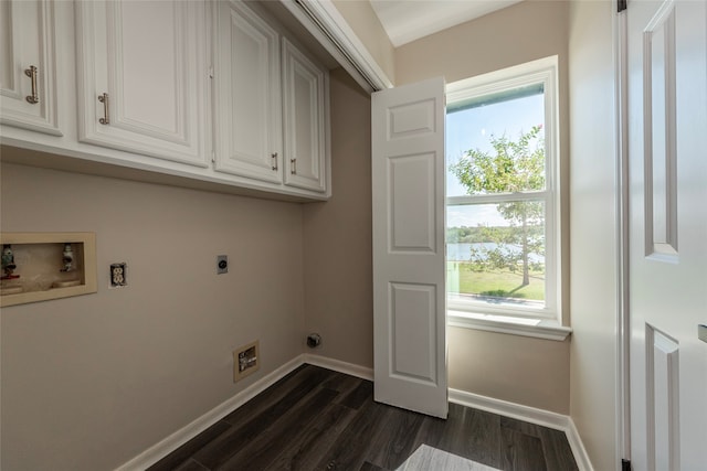 washroom with a healthy amount of sunlight, cabinets, dark hardwood / wood-style flooring, and electric dryer hookup