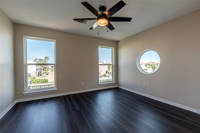 unfurnished room with ceiling fan and dark wood-type flooring