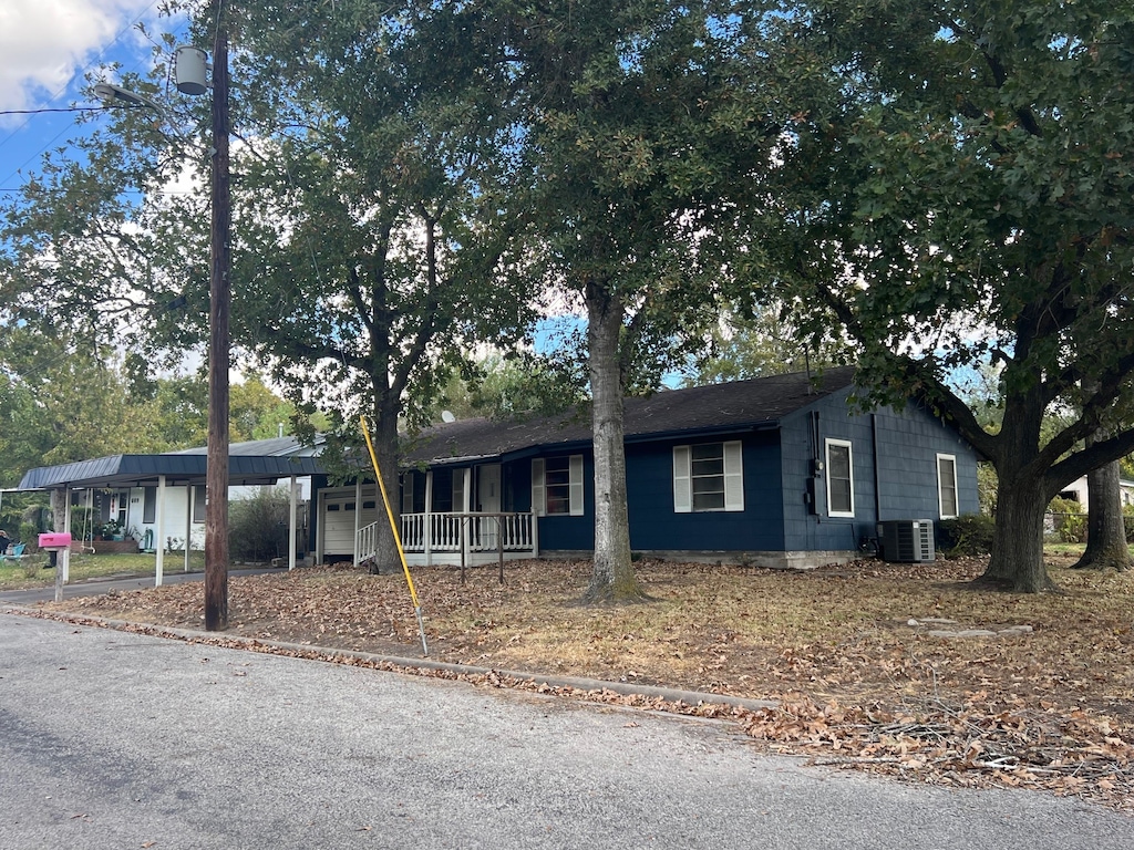 ranch-style house with cooling unit and covered porch