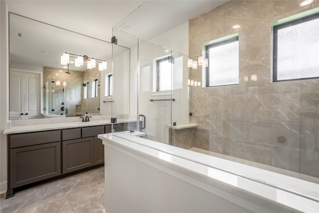 bathroom with vanity and a shower with door