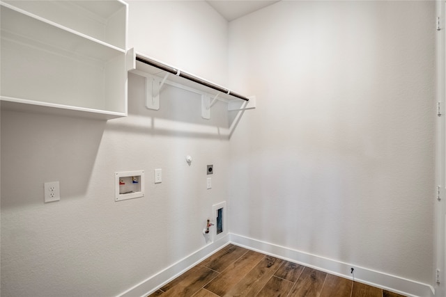 clothes washing area featuring washer hookup, hookup for an electric dryer, gas dryer hookup, and dark hardwood / wood-style flooring