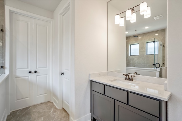 bathroom with walk in shower and vanity