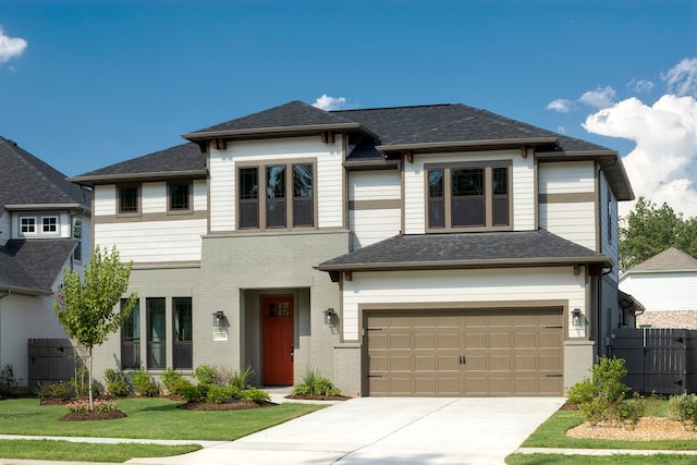 prairie-style home with a garage and a front yard