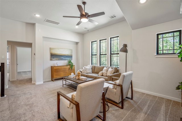 carpeted living room with ceiling fan and a healthy amount of sunlight