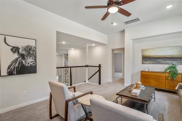 carpeted living room featuring ceiling fan