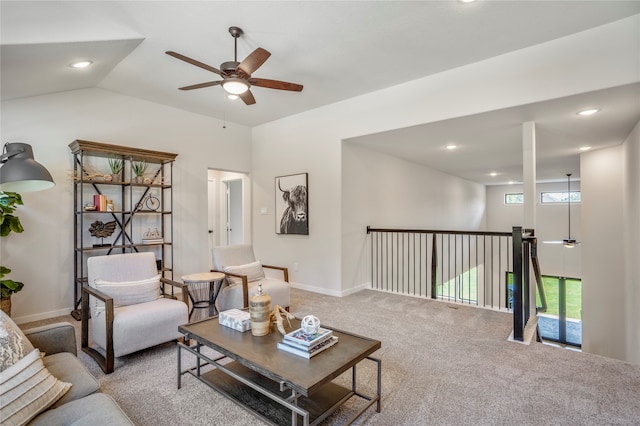 living room with ceiling fan, carpet flooring, and vaulted ceiling