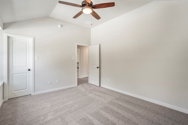 carpeted spare room featuring ceiling fan and vaulted ceiling