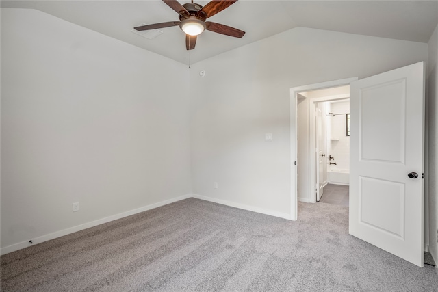 carpeted spare room with lofted ceiling and ceiling fan