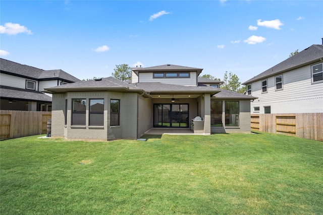 back of house with a yard, ceiling fan, and a patio