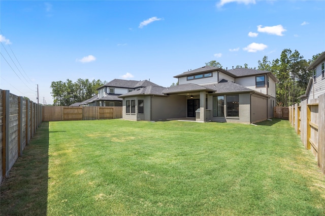 back of house with a yard and a patio area