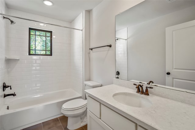 full bathroom with tiled shower / bath, vanity, toilet, and tile patterned floors