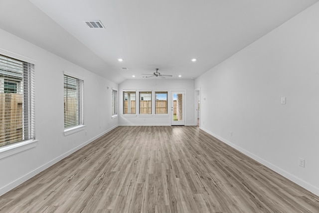 unfurnished living room with light wood-type flooring, ceiling fan, and vaulted ceiling