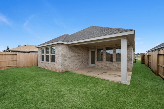 rear view of house with a patio and a yard