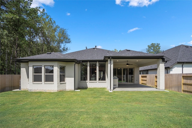 back of house with a patio area, a lawn, and ceiling fan