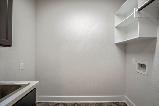 laundry area featuring washer hookup and cabinets