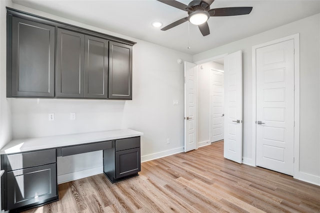 office area featuring ceiling fan, light hardwood / wood-style flooring, and built in desk