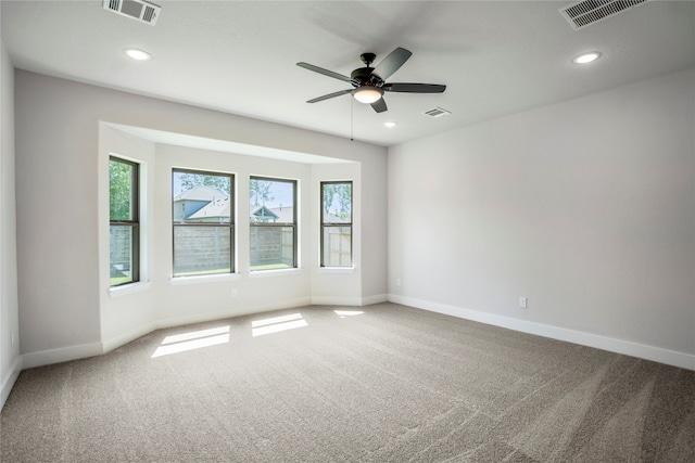 spare room featuring carpet flooring and ceiling fan