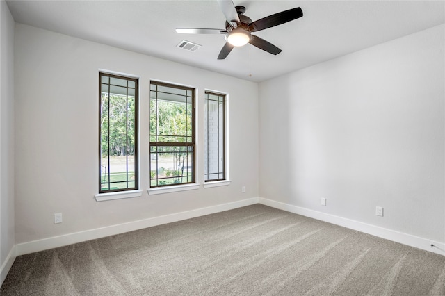 unfurnished room featuring ceiling fan and carpet flooring