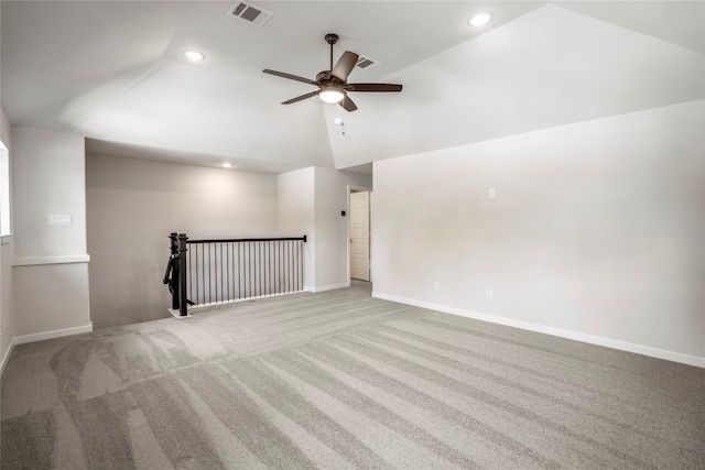 carpeted empty room featuring ceiling fan and vaulted ceiling