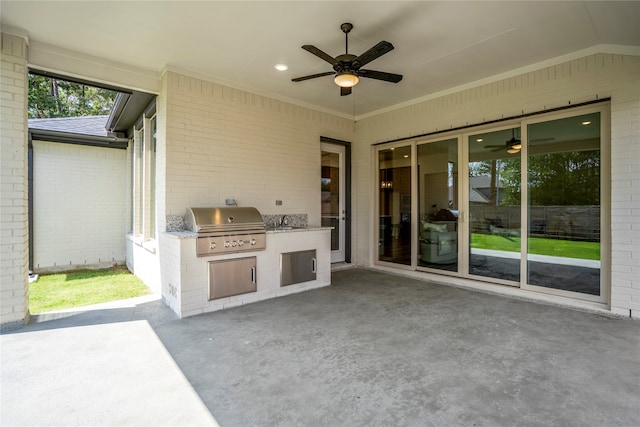 view of patio with an outdoor kitchen, area for grilling, and ceiling fan