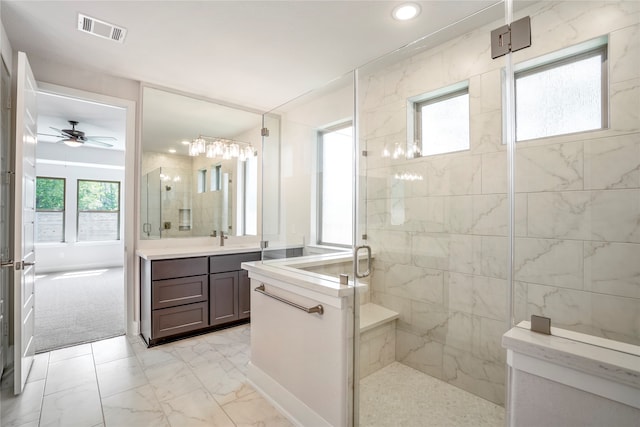 bathroom with ceiling fan, vanity, and an enclosed shower