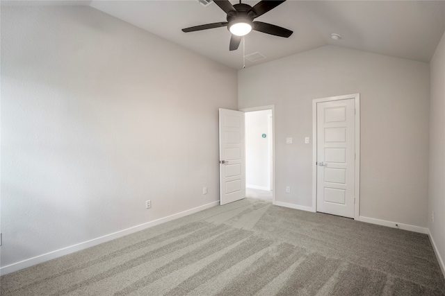 unfurnished bedroom featuring light carpet, vaulted ceiling, and ceiling fan