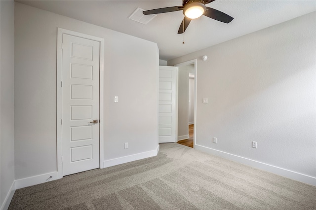 unfurnished bedroom with ceiling fan and light carpet