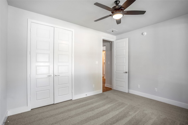 unfurnished bedroom featuring ceiling fan, carpet floors, and a closet