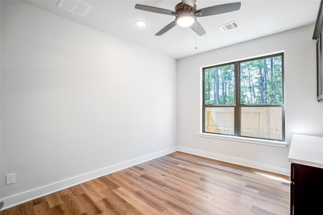 empty room featuring ceiling fan and light wood-type flooring