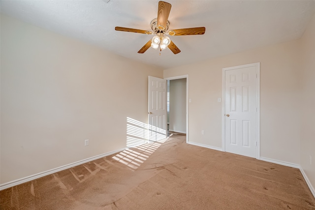 unfurnished bedroom featuring ceiling fan and light colored carpet