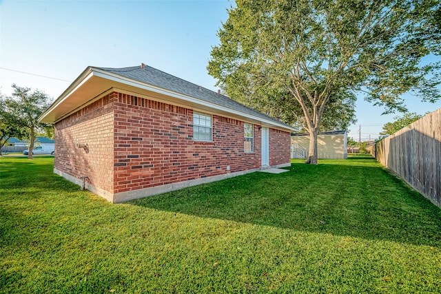 view of side of home with a lawn