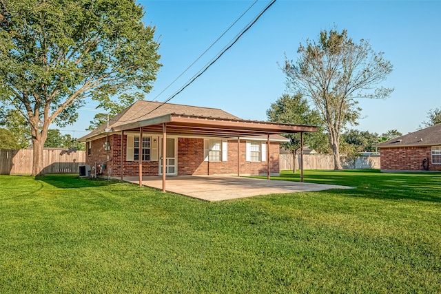 rear view of house featuring a patio area, a lawn, and central AC unit