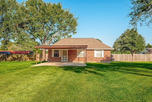 back of property featuring a yard and a patio