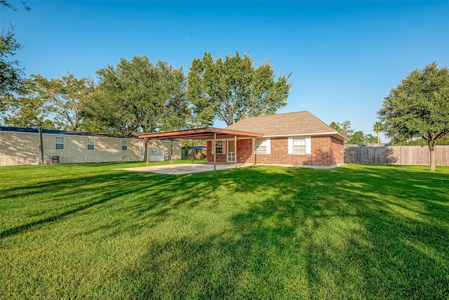 back of property featuring a patio and a lawn