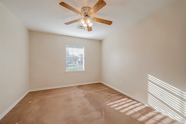 empty room with ceiling fan and light colored carpet