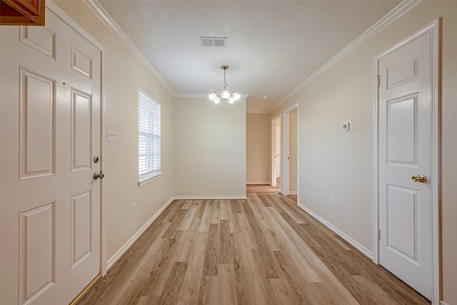 interior space with crown molding, a notable chandelier, and light wood-type flooring