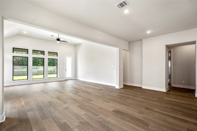 spare room with ceiling fan, vaulted ceiling, and dark hardwood / wood-style flooring