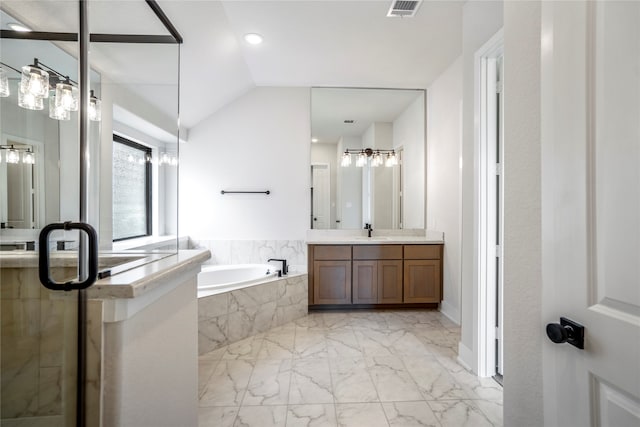 bathroom with vanity, tiled bath, and vaulted ceiling