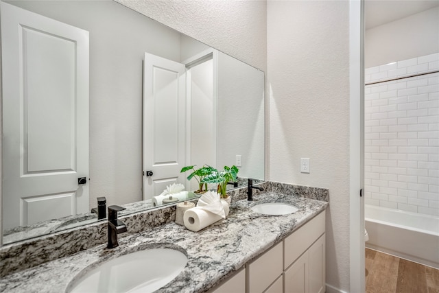 full bathroom with vanity, toilet, shower / washtub combination, and hardwood / wood-style flooring