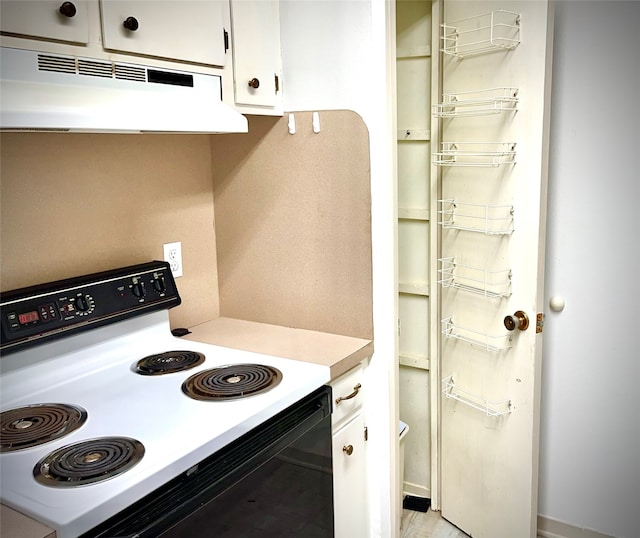 kitchen with white electric range and white cabinetry