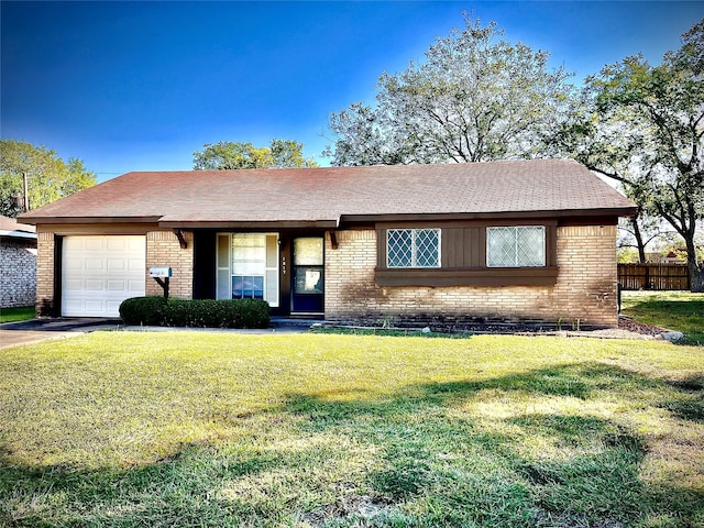 single story home featuring a front yard and a garage