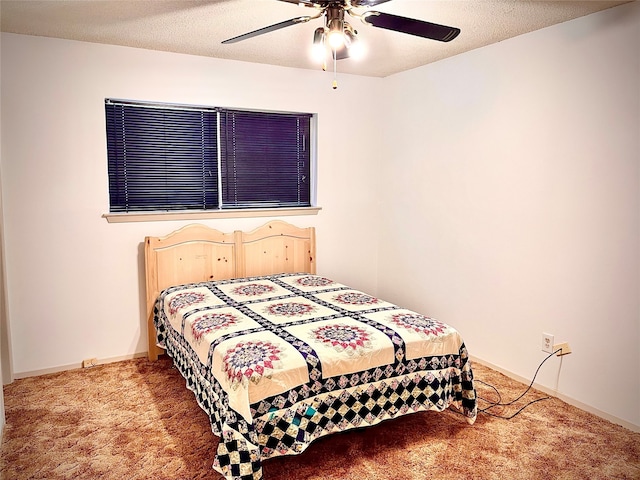 carpeted bedroom with ceiling fan and a textured ceiling