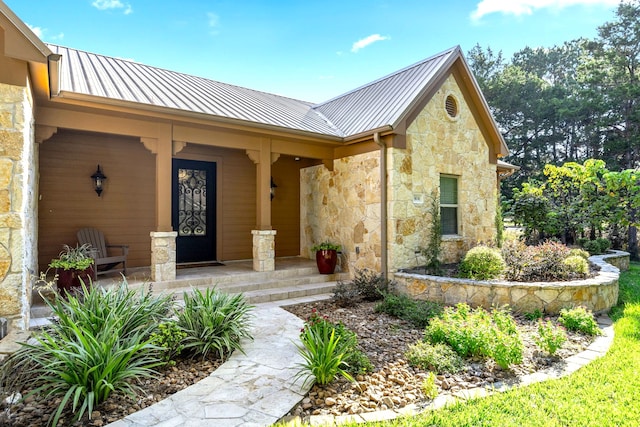 view of exterior entry featuring covered porch